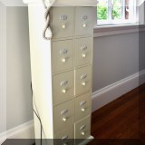 F22. 10-Drawer painted storage cabinet with numbered drawers. 35”h x 14”w x 9”d - $45 